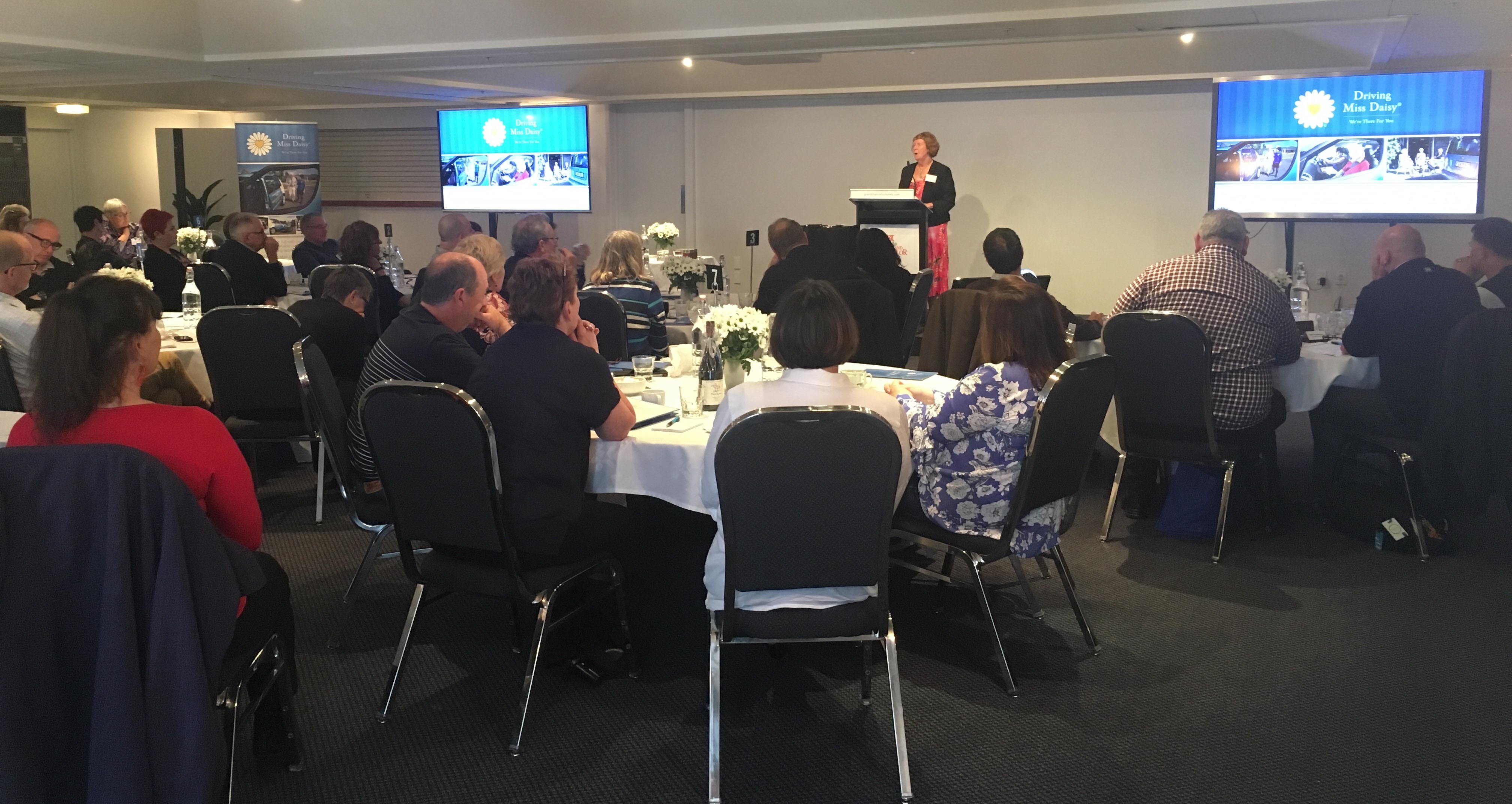 A slightly different angle of the back of the room with Pam presenting.